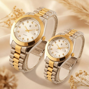 Two watches with gold and silver bands on a light gray background